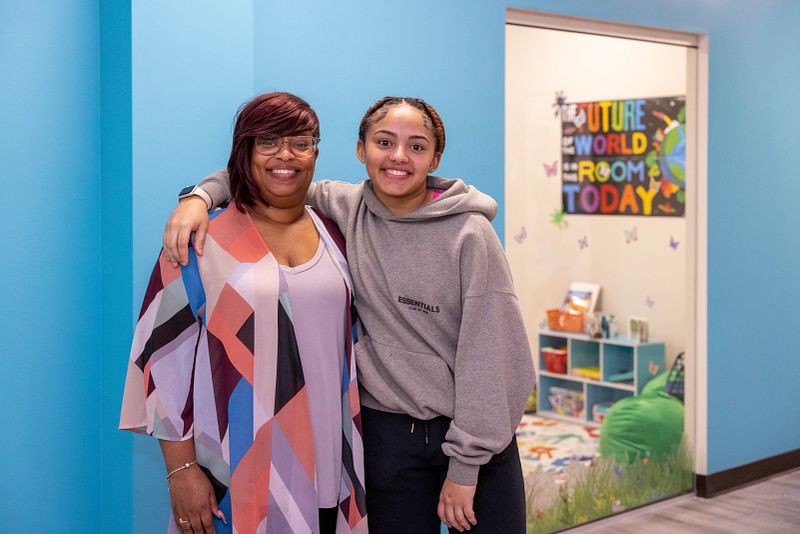 a single mom and her teenage daughter smile for the camera